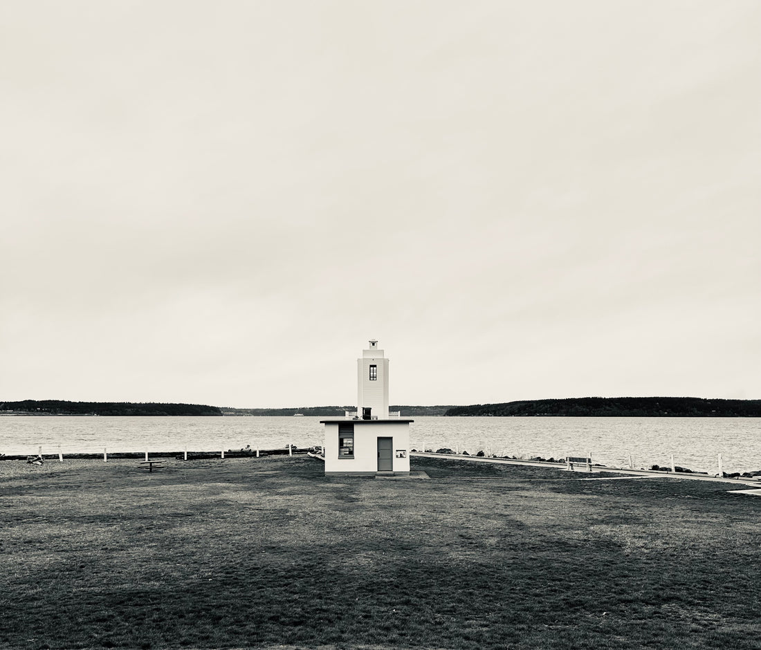 Black and white photo of a lighthouse in a field